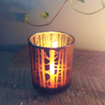 Load image into Gallery viewer, one tealight burning in forest candle holder
